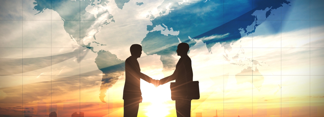 Two business man shake hand silhouettes city with world maps
